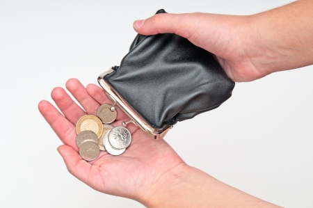 Hands holding purse and few coinsの写真素材