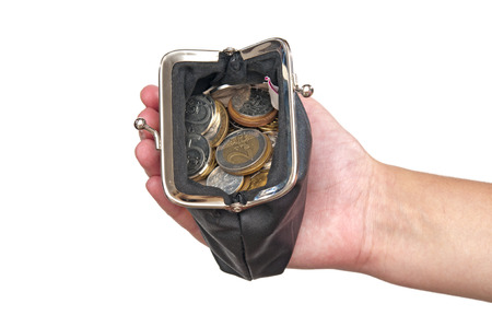 Hand holding purse with coinsの写真素材