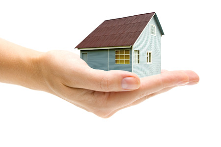 Hand and house on white の写真素材