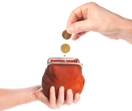Hand throwing coin in antique purseの写真素材