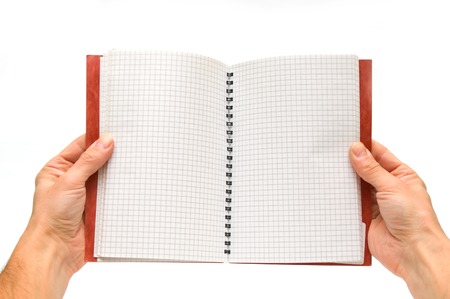 Hands holding open spiral notebook