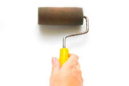 Hand and paintbrush on white backgroundの写真素材