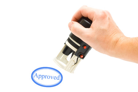 Hand and stamp "Approved" の写真素材