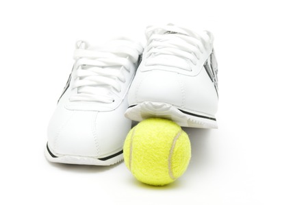 Sneakers and tennis ball on white の写真素材
