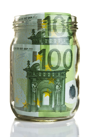 Euro banknotes in glass jar on white の写真素材