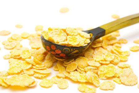 Cornflakes and wood spoon on isolated
