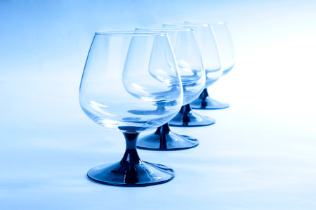 Four wineglasses on blue backgroundの写真素材