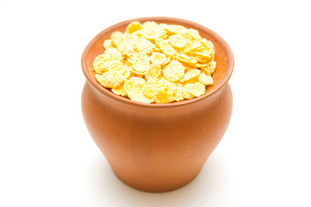 Earthenware pan with corn flakes の写真素材