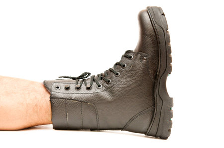 Boot on the foot isolated on white backgroundの写真素材