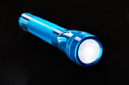 Blue pocket flashlight on blackの写真素材