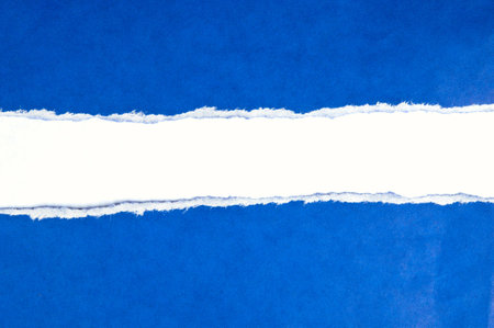 Torn blue paper with white spaceの写真素材