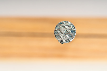 Nail in wooden bar closeupの写真素材