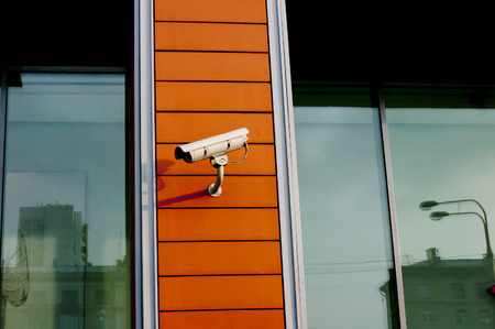 Security-camera on yellow wallの写真素材