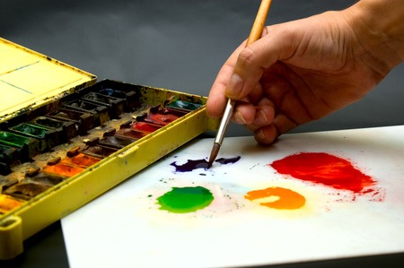Hand holding paintbrushの写真素材