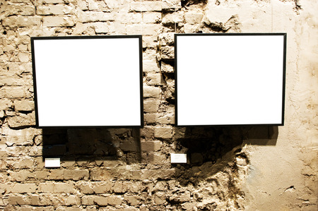 Two frames on brick wall