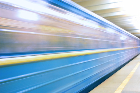 Moving train in subway station