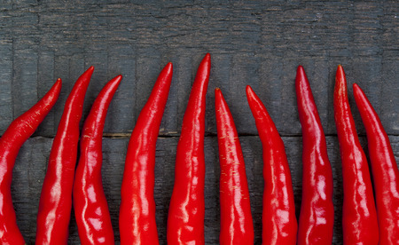 Red hot pepper closeup on wooden background