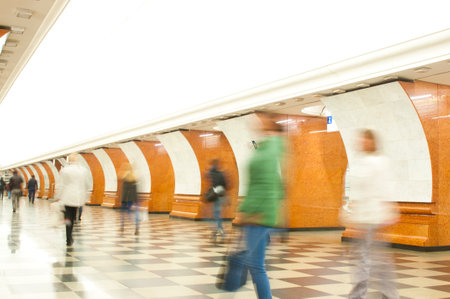 Motion blurred commuters walking at subway stationのeditorial素材