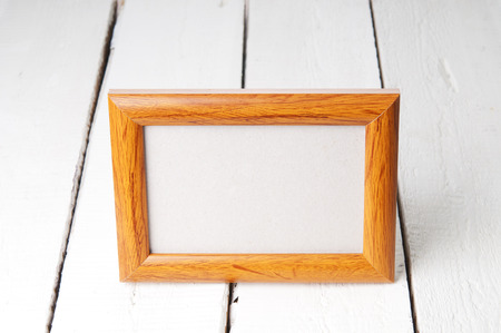 Empty picture frame on wooden backgroundの写真素材