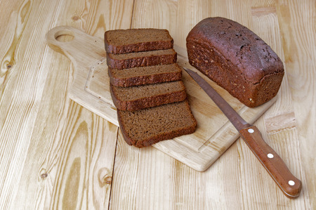 Slices of rye bread on wooden background