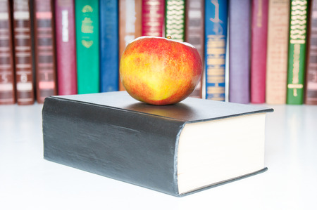 Books with apple on white backgroundの写真素材