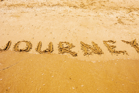 Journey written on sandy beachの写真素材