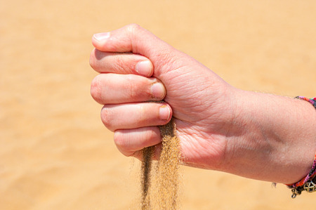 Hand pours sandの写真素材