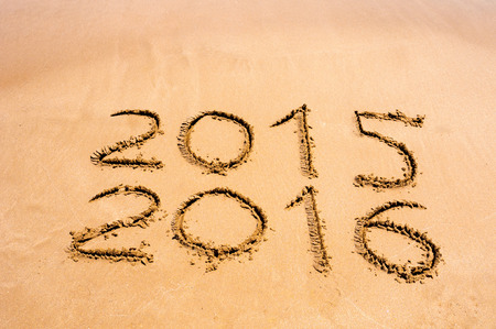 New Year 2016 is coming concept - inscription 2015 and 2016 on a beach sandの写真素材