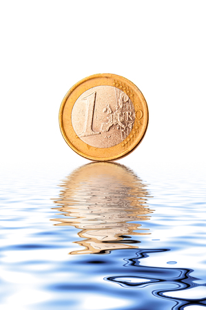One euro coin with reflection on waterの写真素材