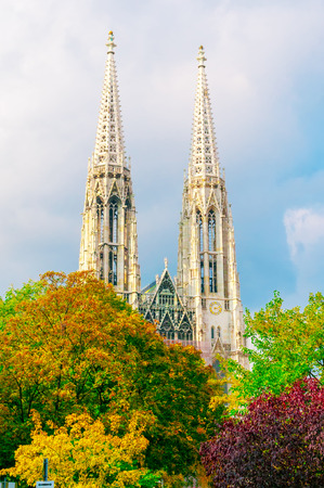 Votive Church (Votivkirche) and autumn trees in Vienna, Austria の写真素材