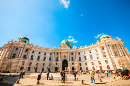 Michaelerplatz and Hofburg Palace with tourists in bright sunny day in Vienna, Austriaのeditorial素材