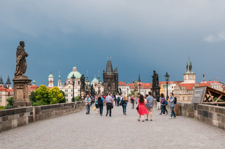 PRAGUE, CZECH REPUBLIC - JUNE 19, 2016: Charles Bridge and tourists. It is famous historic bridge that crosses Vltava river.のeditorial素材