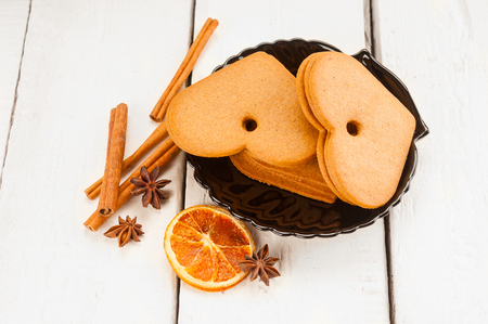 Gingerbread cookies and cinnamon on wooden backgroundの写真素材