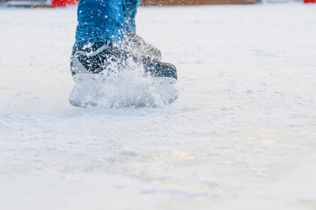 Legs of skater in motion at skating rinkの写真素材