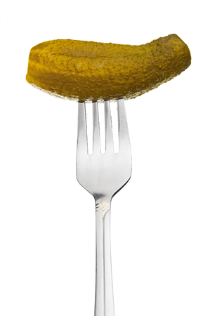 Fork with pickled cucumber closeup on white backgroundの写真素材