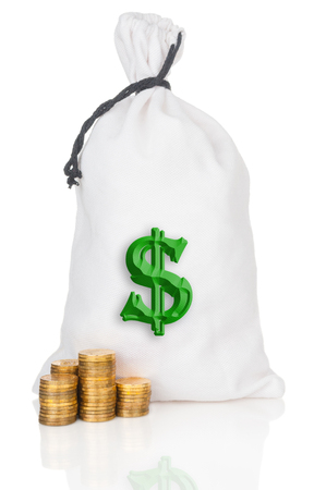 Money bag and stacks of coins on white backgroundの写真素材
