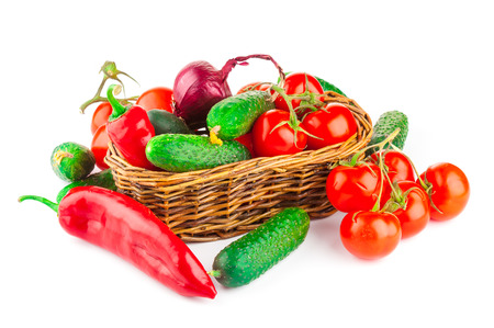 Ripe vegetables in wicker basket isolated on white backgroundの写真素材