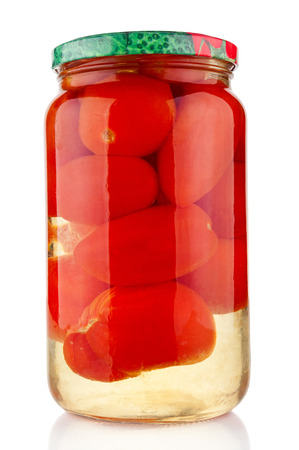 Glass jar of pickled tomatoes on white backgroundの写真素材