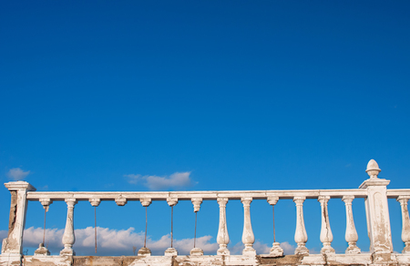 Damaged balustrade on blue sky backgroundの写真素材