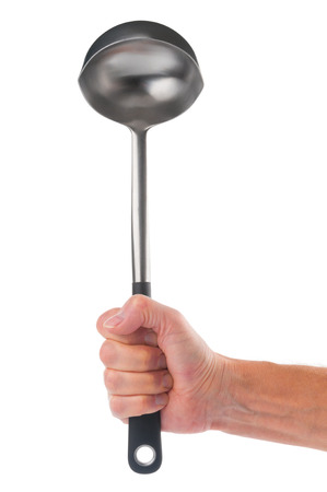 Hand holding metal ladle on white backgroundの写真素材