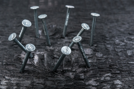 Metal nails close up on wooden backgroundの写真素材