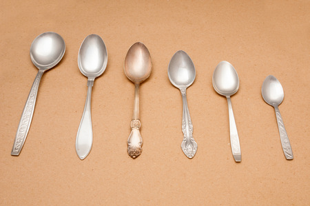 Vintage spoons close up on brown background