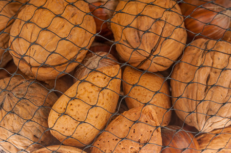 Different kind of nuts close up in grid package