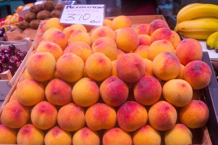 Ripe peaches on market stallの写真素材