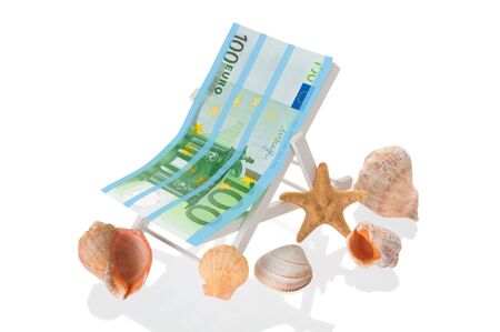 Vacation concept with beach chair, euro banknote and seashells on white backgroundの写真素材