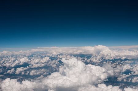 Above view from plane on blue sky and cloudsの写真素材