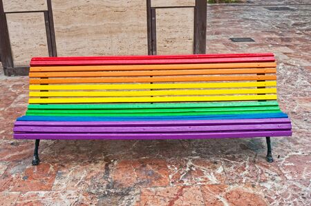 Rainbow coloured bench  in the city in Valencia, Spainの写真素材