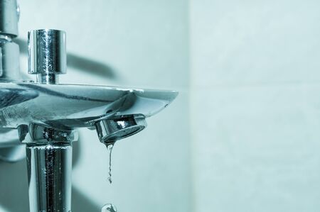 Tap with falling water dropsの写真素材