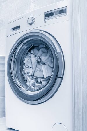 Wash clothes in washing machine close up. Toned imageの写真素材