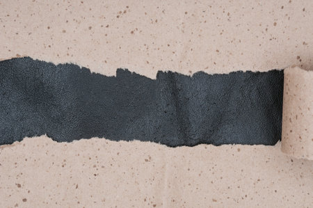 Torn crumpled paper on leather material backgroundの写真素材
